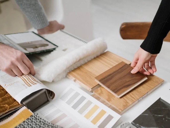 Comparing flooring samples in a design consulation